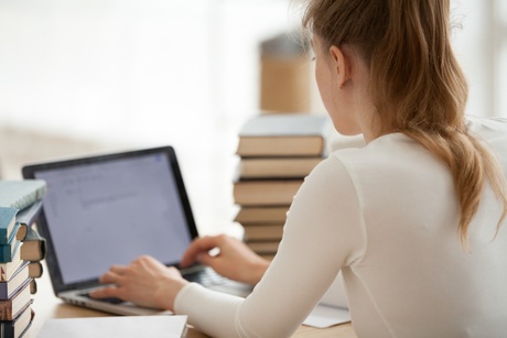 Girl on a Laptop with Books