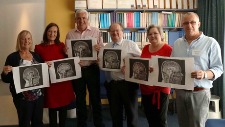 Some of the Children of the 1950s volunteers posing with their own brain scans, taken as part of the STRADL study into depression