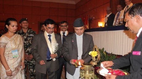 The Minister of Health & Population lighting the candle to open the event