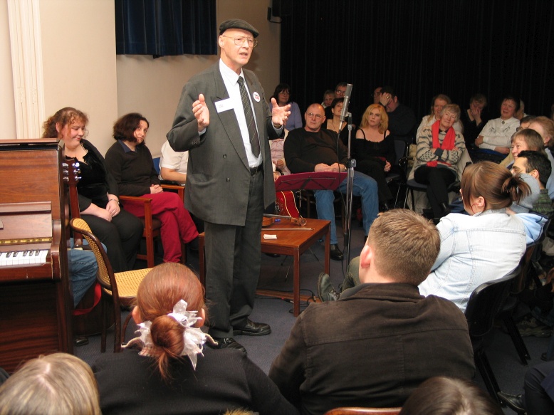 Man standing telling a story surrounded by audience