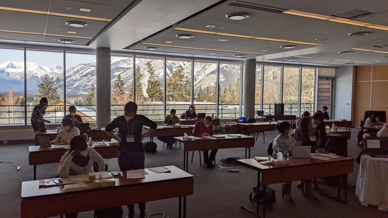 Photograph of group work at the 2021 DCE course in Banff, Canada. Physical distancing and masks worn as COVID transmission mitigation.