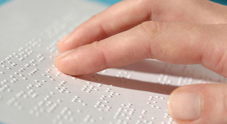 Image of a person reading braille