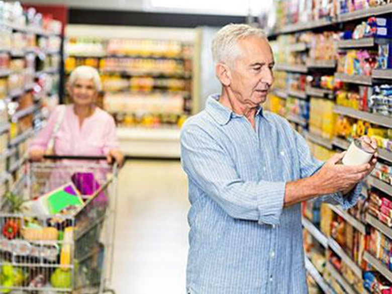 Elderly couple shopping in supermarket