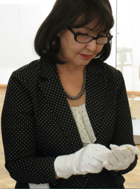 The Director of the National Art Museum, Asya Gabysheva, holds an ivory figure. Courtesy of Eleanor Peers