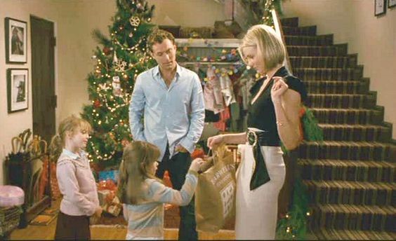 A scene from the film showing the main character presenting a gift to two small children