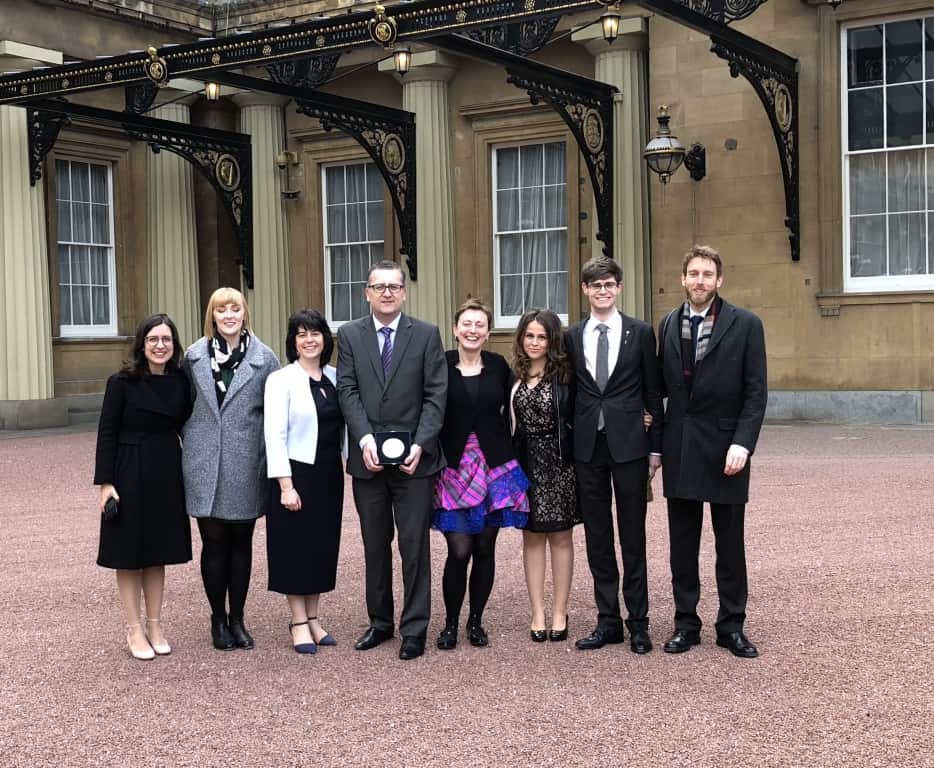 8 people standing outside Buckingham Palace