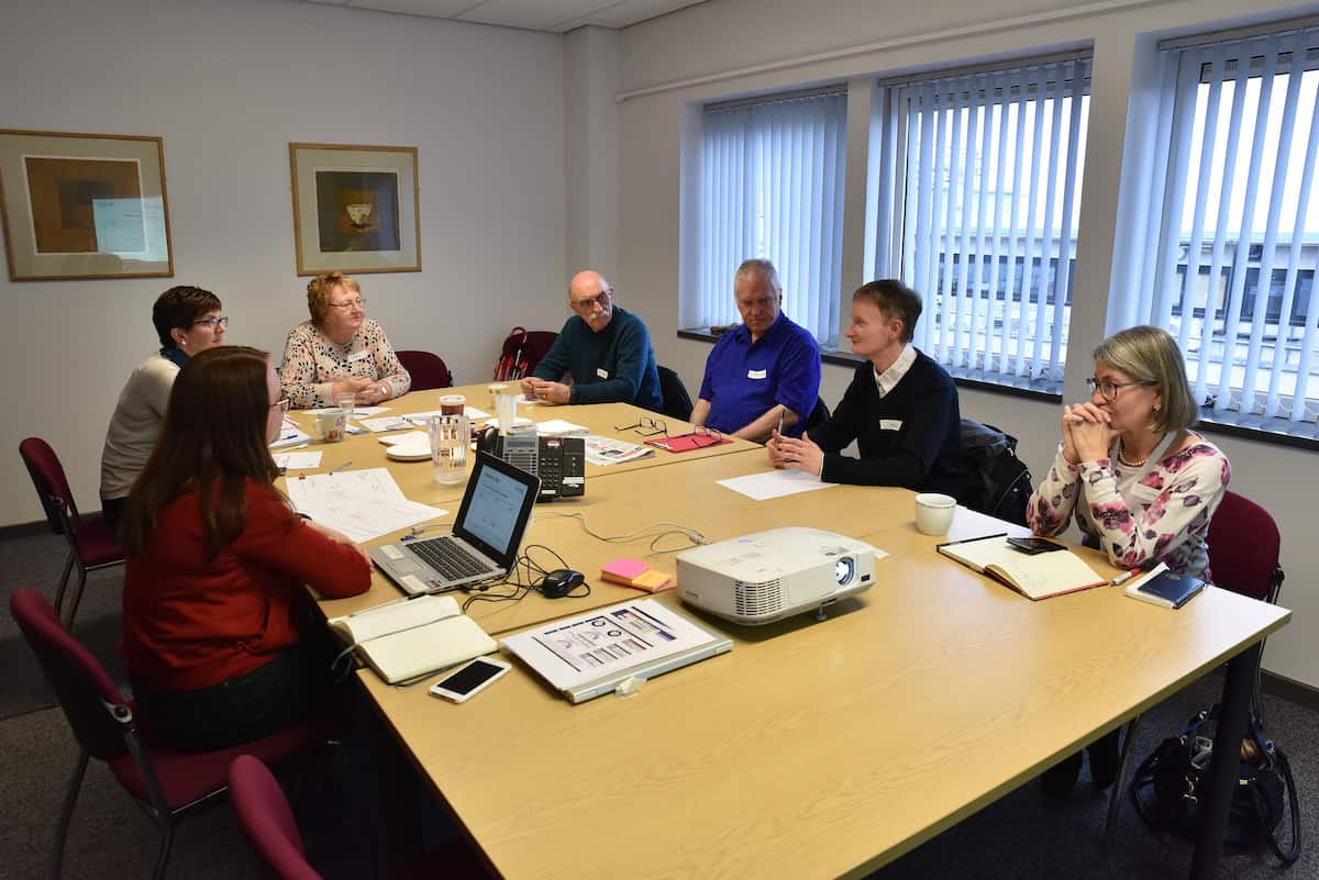 People in classroom around table