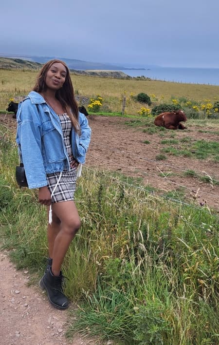 Woman next to coast and cow