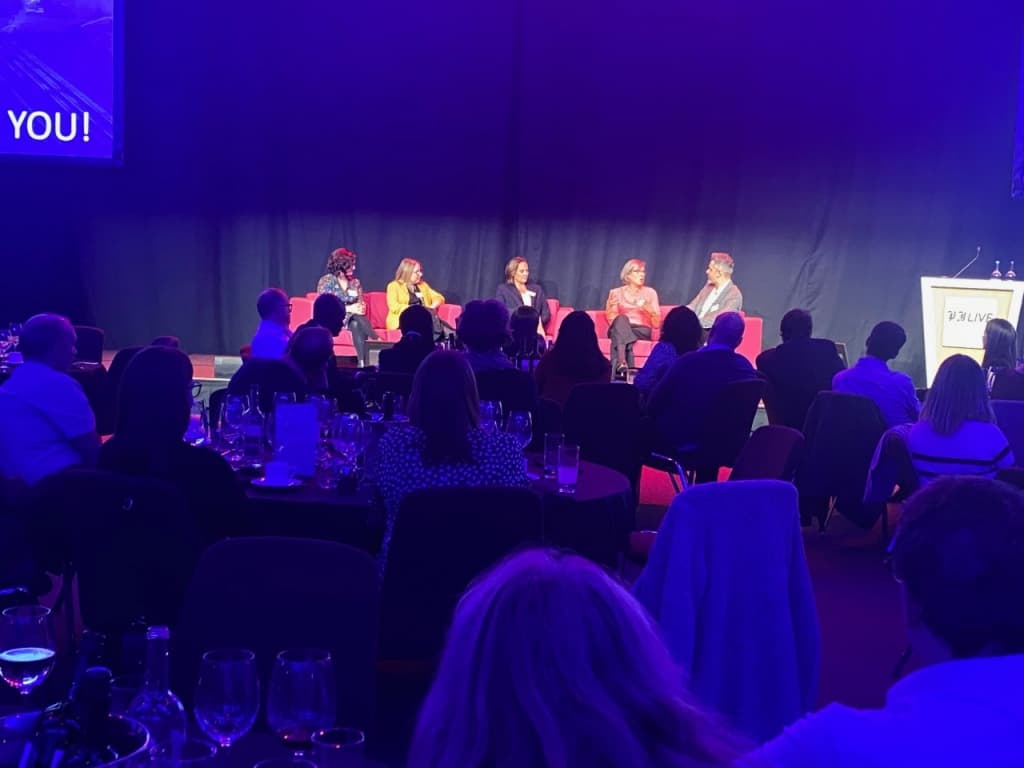 people on a stage on a sofa