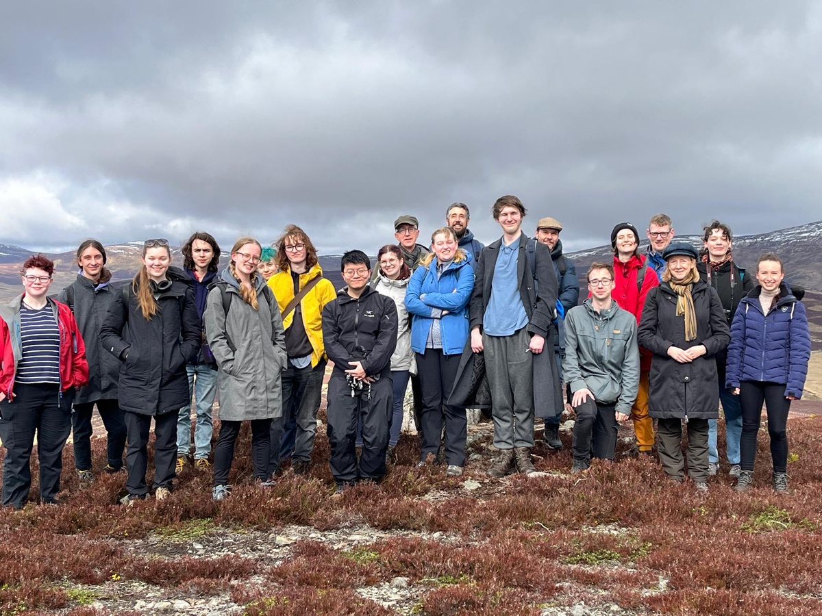 A group of Aberdeen Philosophy students standing on a peak in the Cairngorms National Park.