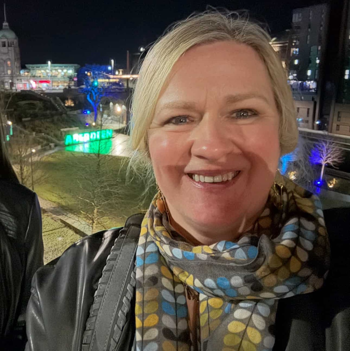 Audrey Thain smiling in front of Union Terrace Gardens at Night in Aberdeen