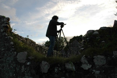 Silhoutte of man using video camera