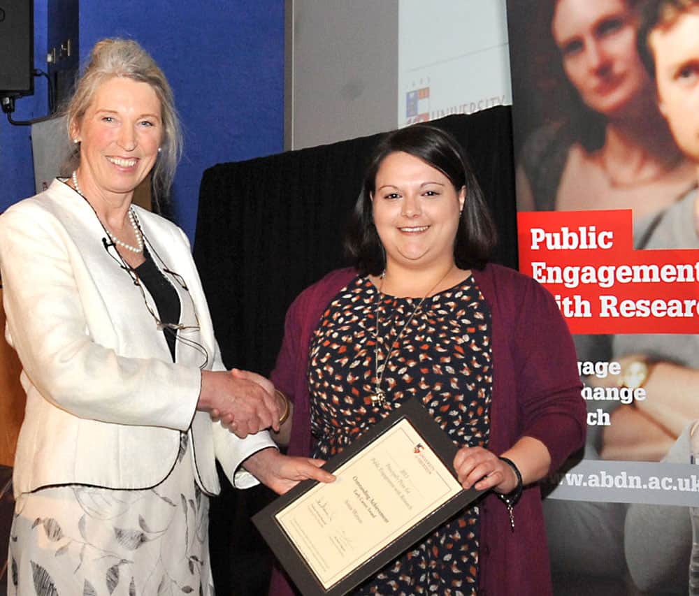 Two women holding certificate