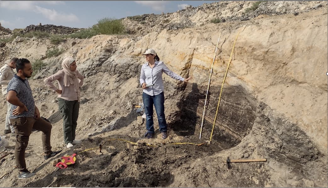 People digging small cliff