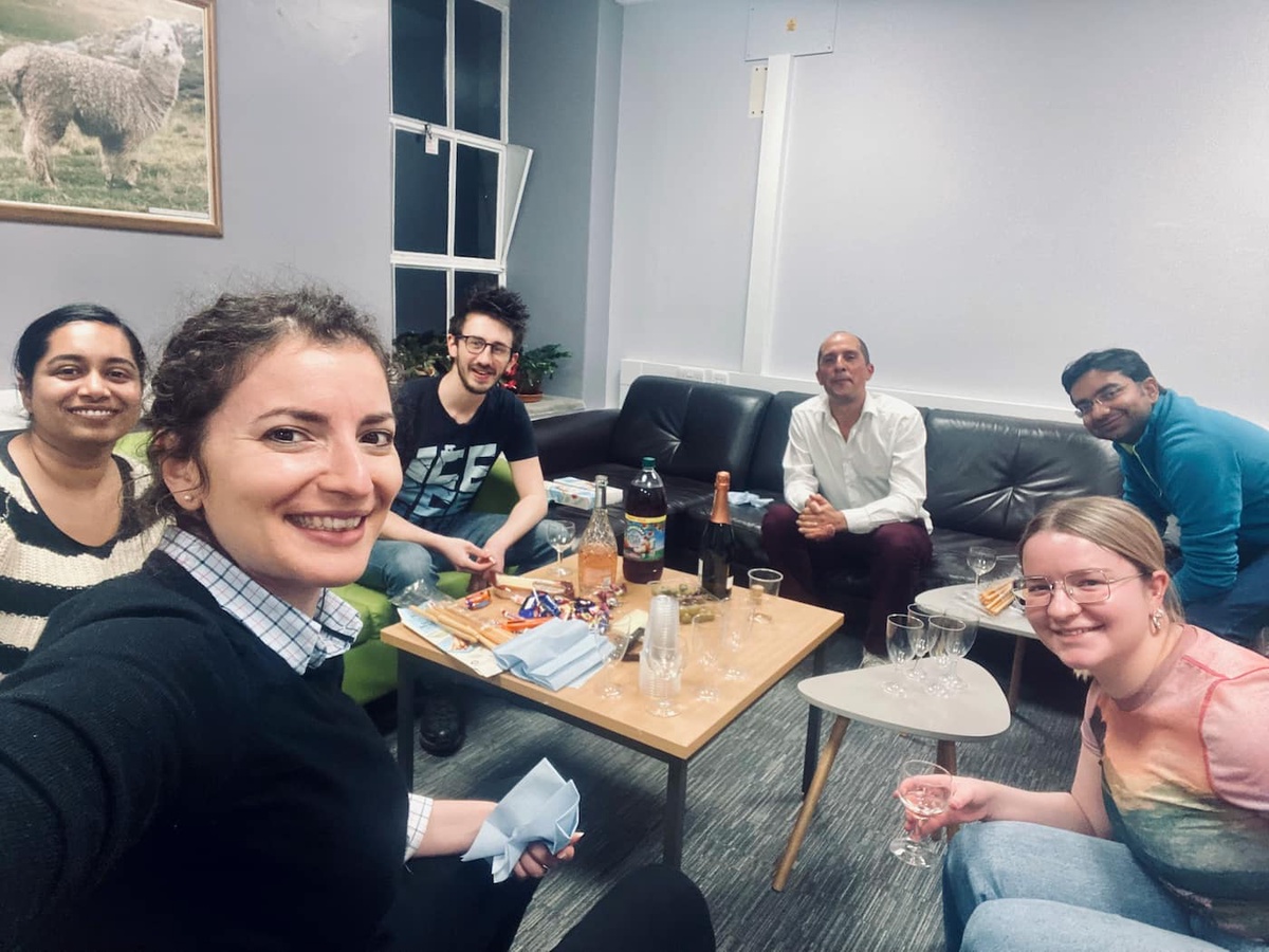 group of people sitting in room on sofas