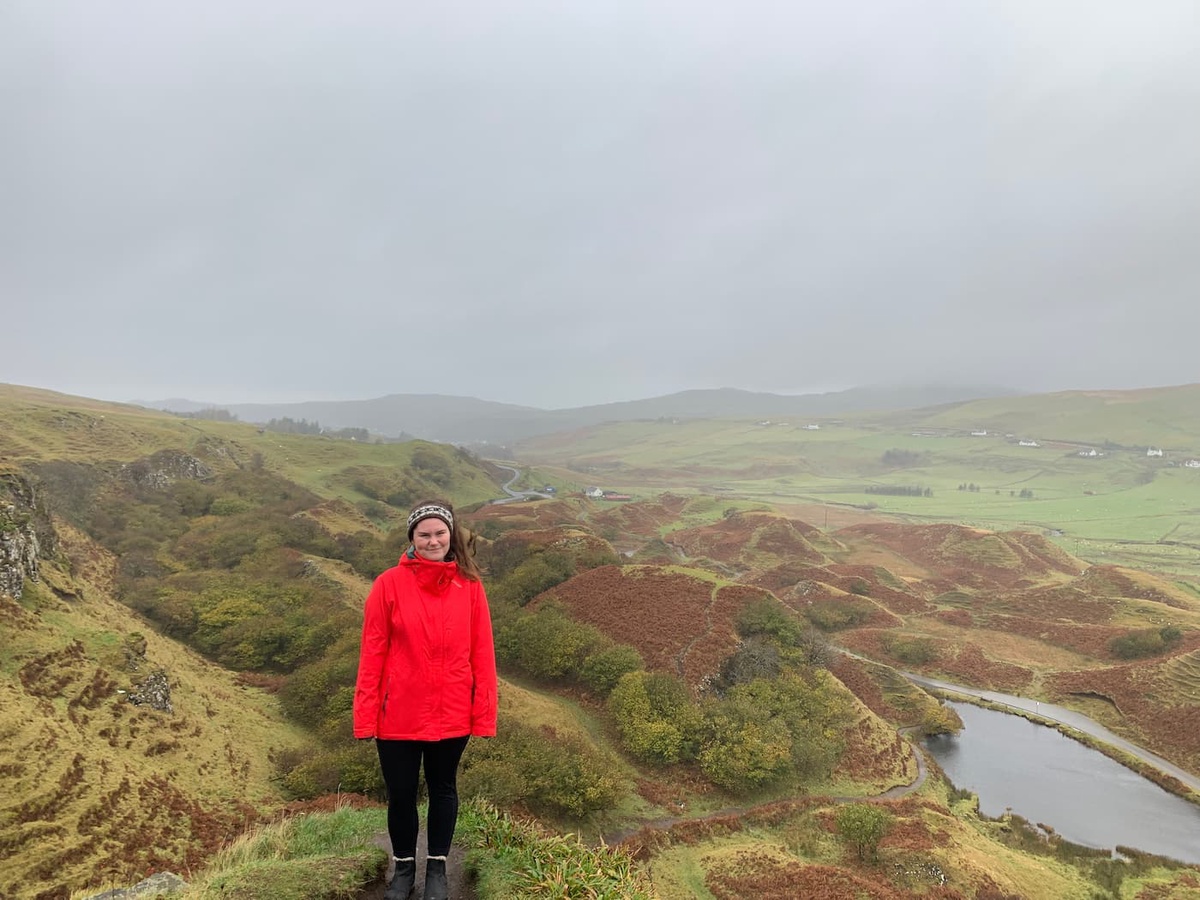 girl in countryside wearing orange jacket