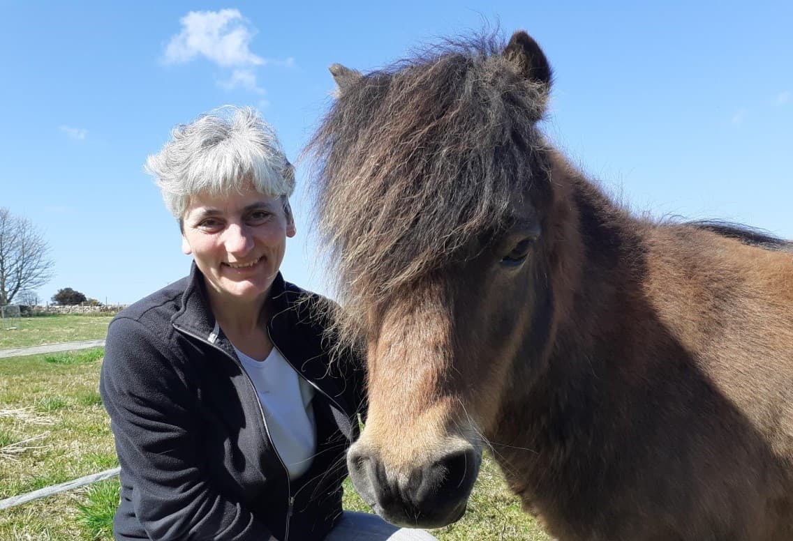 woman with small fuzzy horse