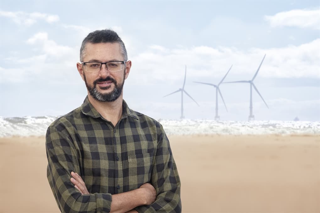 bearded bespectacled man on beach