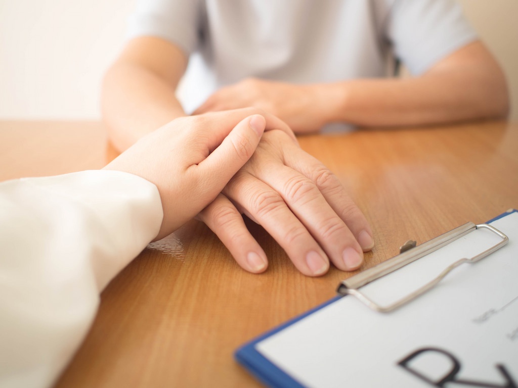 A doctor comforting a patient