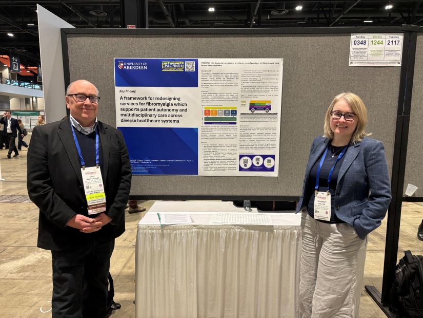 Gary and Rosemary standing beside the poster from PACFiND