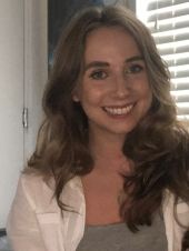 A picture of Lucy standing in front of a window