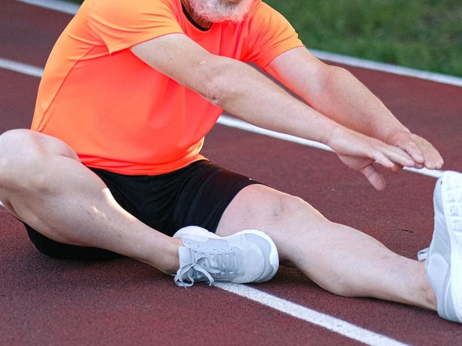 runner on the ground stretching