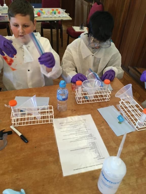 school pupils doing science experiment
