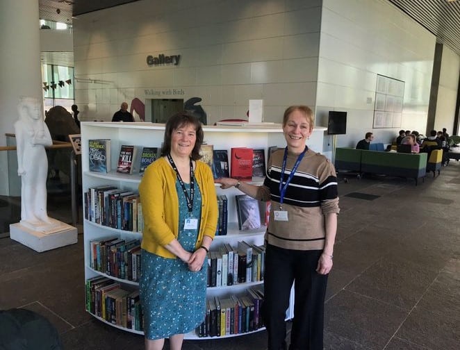2 library workers smiling