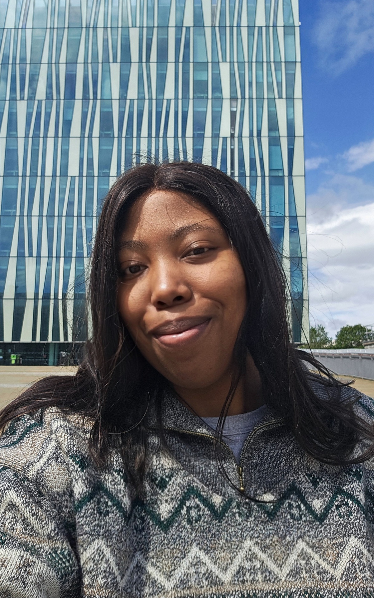 Caroline Peteni, research postgraduate, standing in front of the Sir Duncan Rice library.