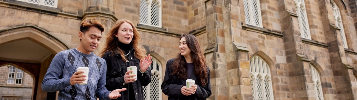 Three students in front of King's Chapel