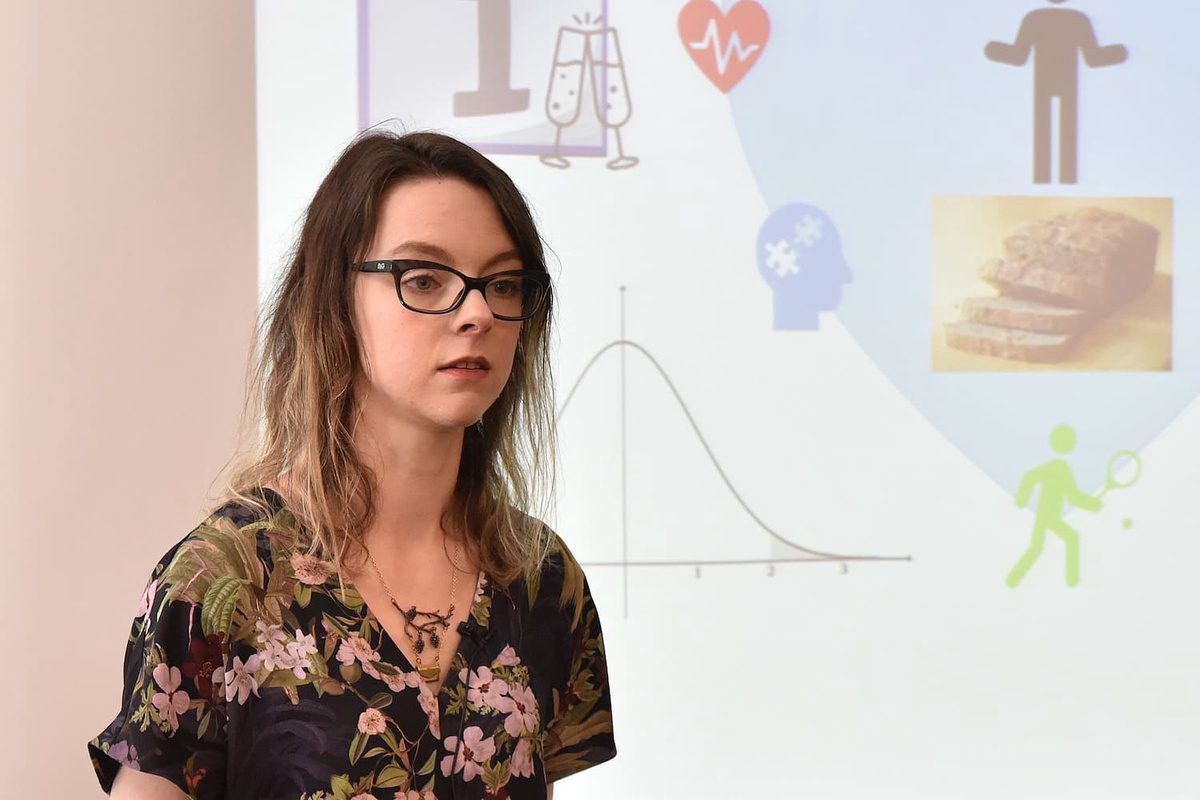 woman with dark hair in front of screen