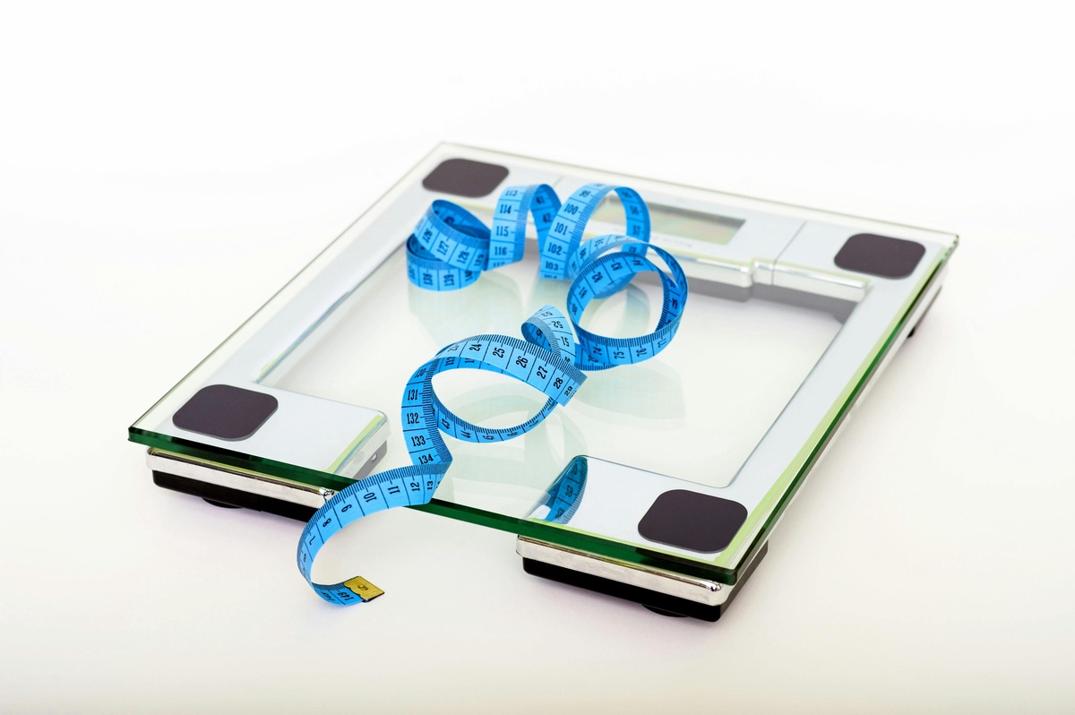 Stock image of bathroom scales and a tape measure