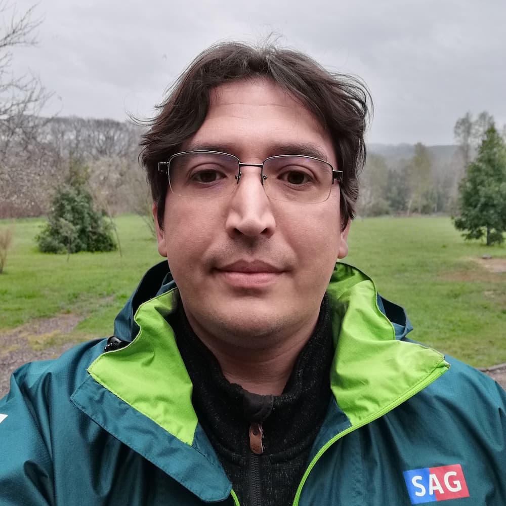 man in bright jacket in rainy field