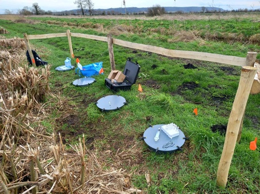 Four H2 flux measurement chambers in a grass field