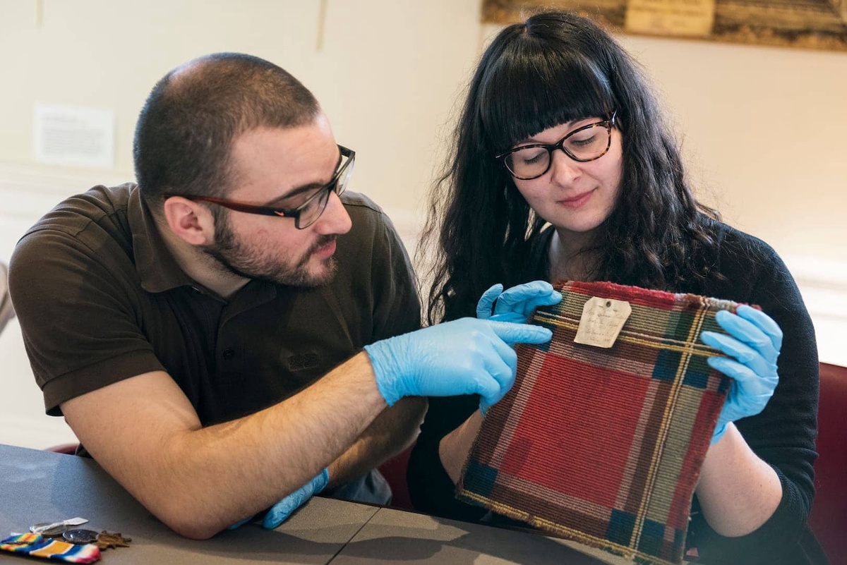Curators discussing about a museum item
