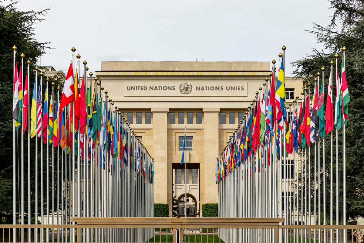 UN building with rows of international flags in front