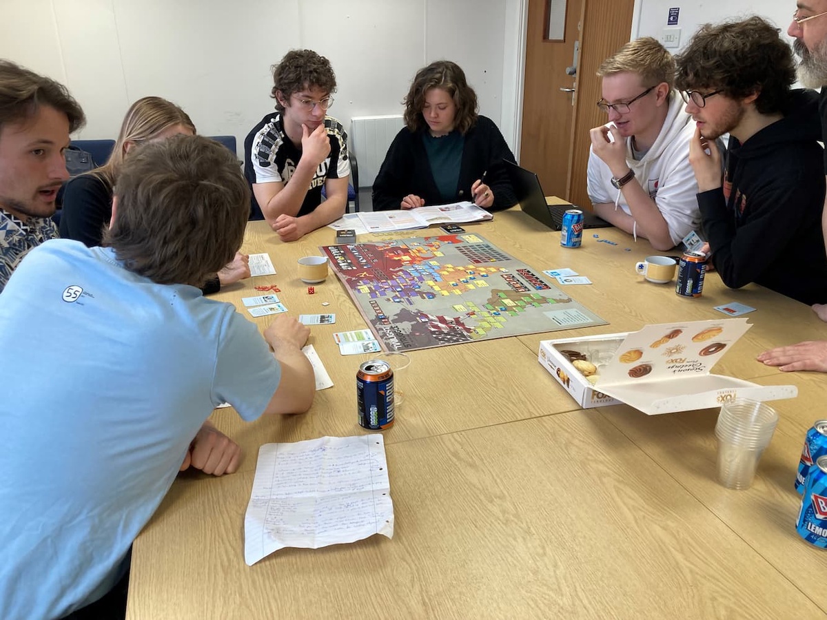 Members of the Wargaming Club discuss strategy