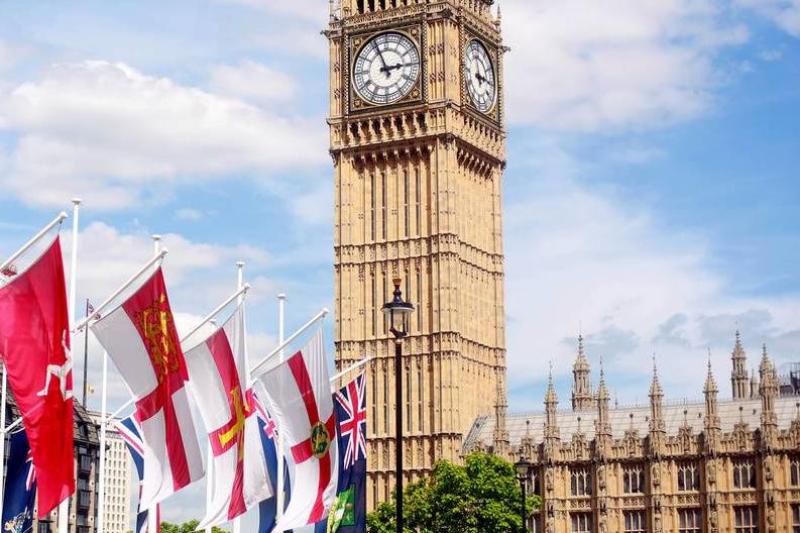 Big Ben and Westminster with various flags in the foreground