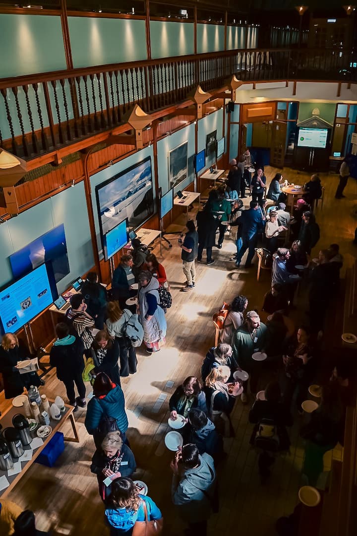 Symposium delegates viewing posters in McKay Hall