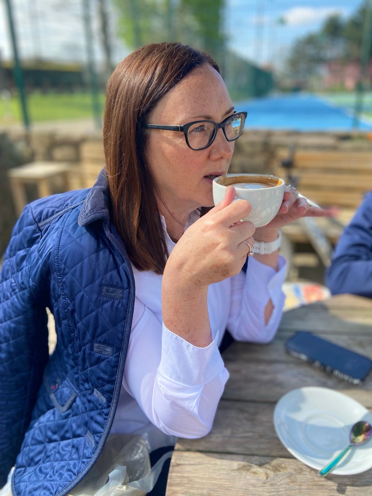 Image shows Linda with a coffee cup
