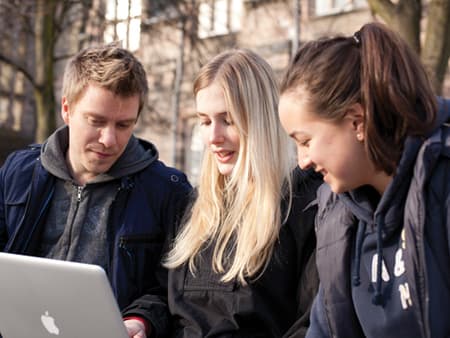 students looking a laptop