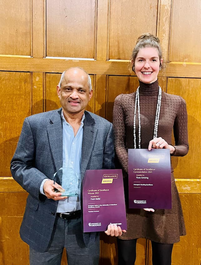 2 people holding certificates in elphinstone hall