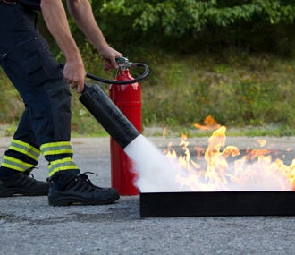 Image of fire extinguisher being used on a fire