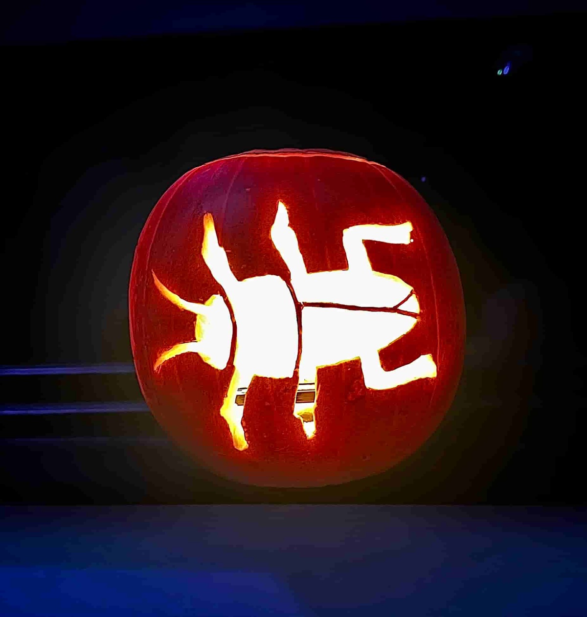 A friendly looking cockroach has been carved out of a pumpkin