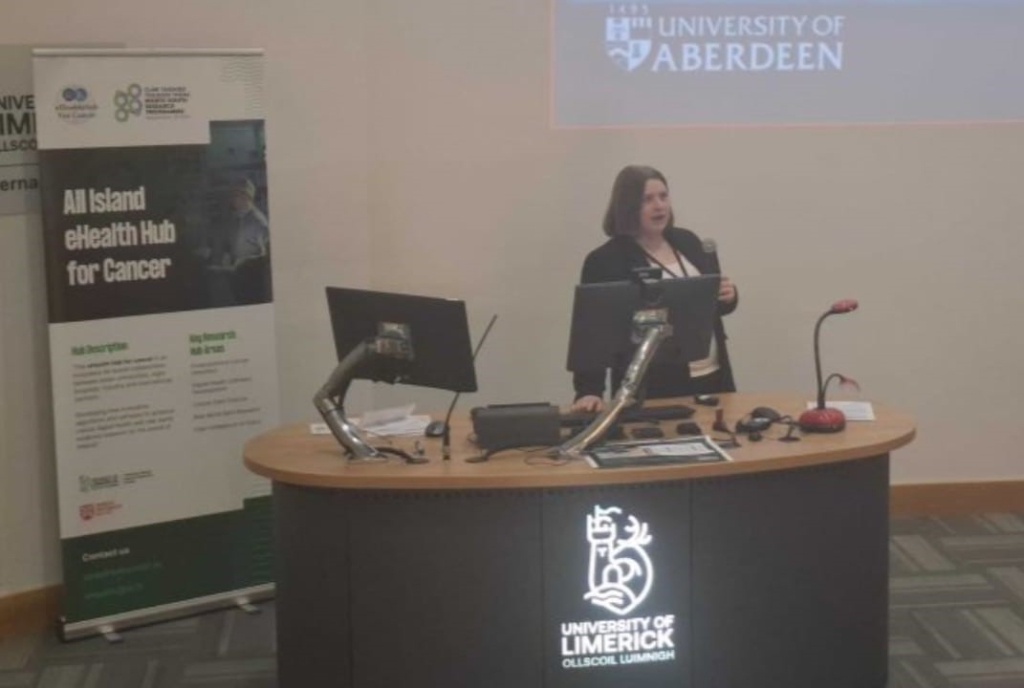 Professor Lesley Anderson giving a presentation at a University of Limerick presentation desk.
