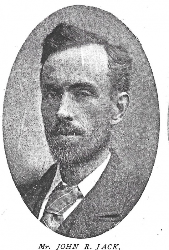 Black and white portrait of Mr John R Jack. Photograph of his bust, side parted hair with short beard and mustache, wearing a suit and tie.