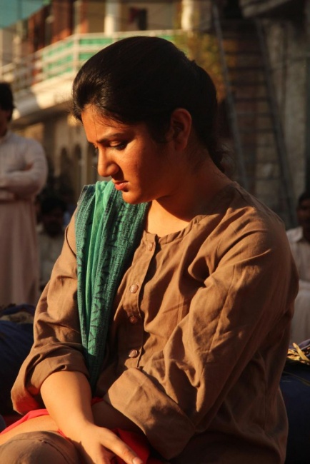 Woman sitting outside looking down