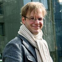 Blonde man with suit coat and scarf