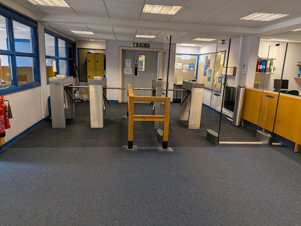 Image shows the entrance of Taylor Library with the old gates