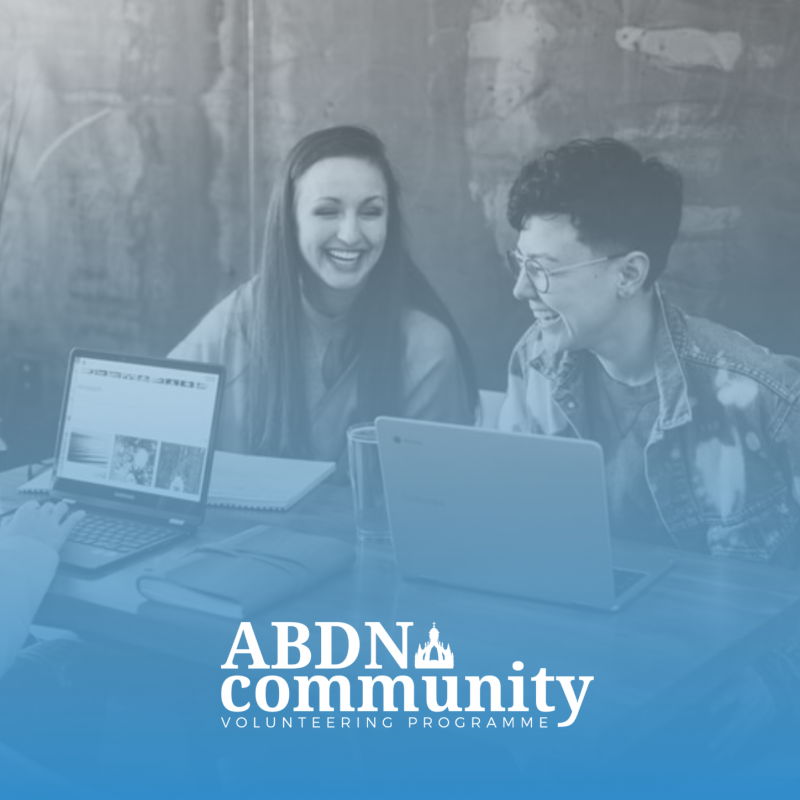 two friends laughing with the ABDNCommuniy logo